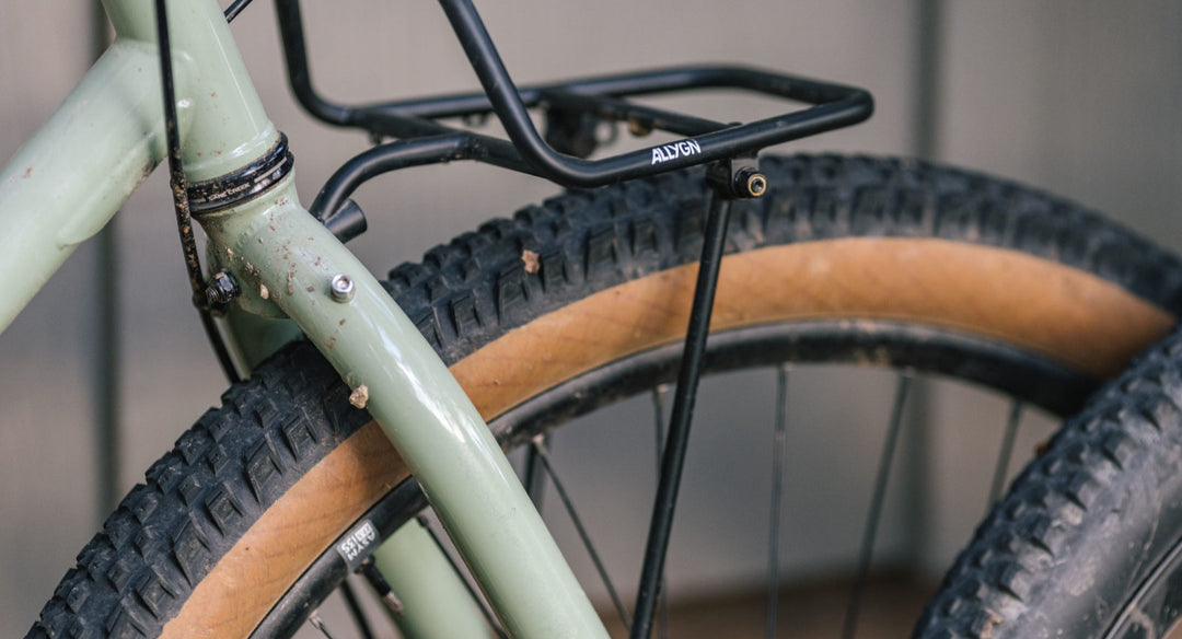 Front cargo rack mounted over a gravel bike wheel