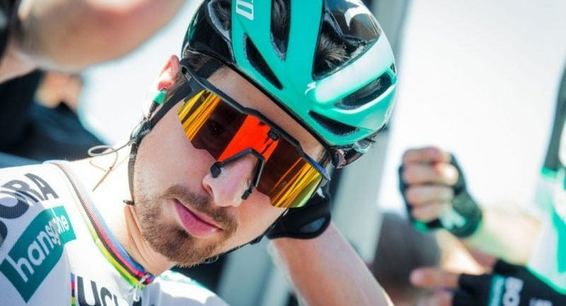 Road cyclist wearing wraparound sunglasses and a helmet