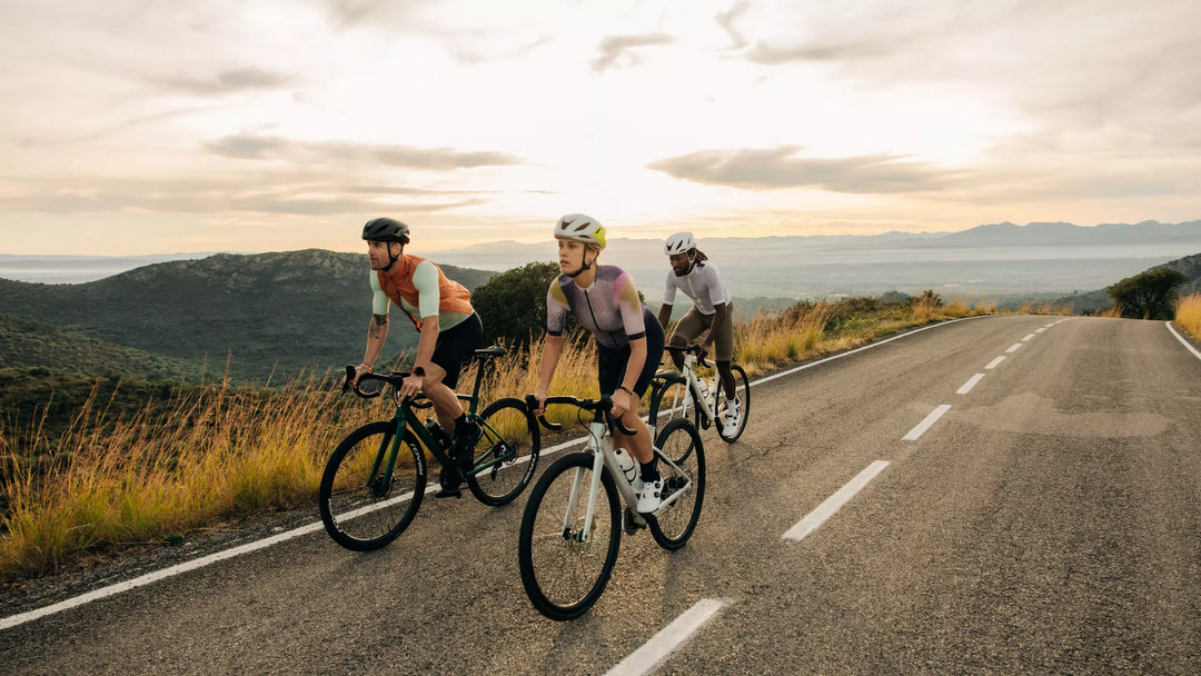Three road cyclists riding on an open road