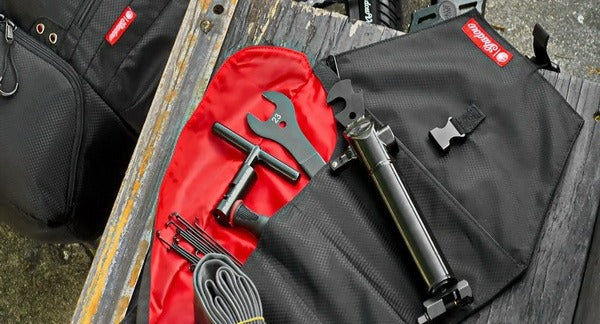 Compact bike tools and a spare tube packed in a bag