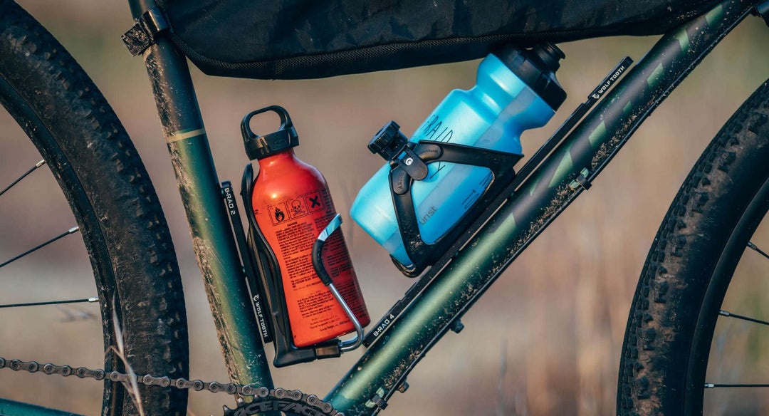 Two water bottles mounted in gravel bike frame cages
