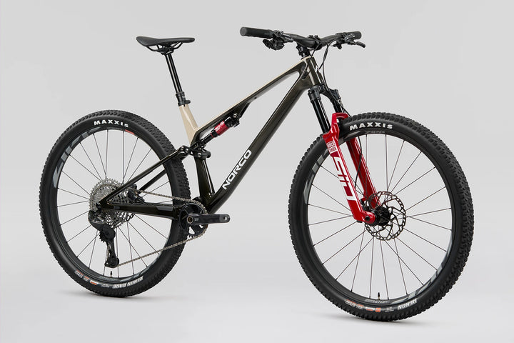 26 Norco Revolver C1 120 Fast Black Raw Carbon Warm Grey quarter-view product image