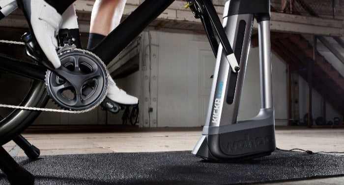 Road bike on an indoor trainer and climbing simulator